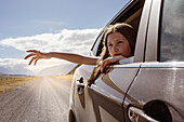 Woman waving from car