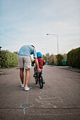 Father teaching son cycling