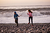 Two girls playing by sea