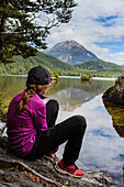Girl sitting at lake