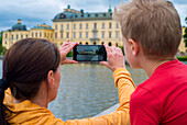 Mother and son taking photo with cell phone