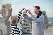 Mother and son stacking rocks