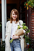 Smiling woman holding bouquet of flowers