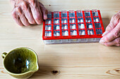 Hands with pills in box