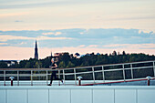 Woman jogging through footbridge