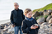 Grandfather with granddaughter on beach