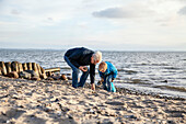 Grandfather with grandson on beach