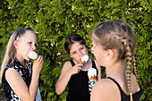 Three girls eating icecream.