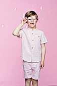 Smiling boy on pink background