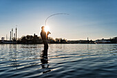 Man fishing at sunset