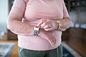 Senior woman using alert bracelet