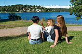 Female friends sitting at water