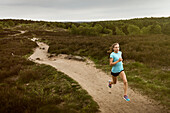 Woman running on graveled road