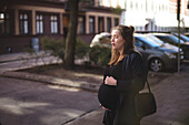 Pregnant woman standing on street