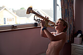 Boy playing on trumpet