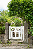 Small white gate leading to garden