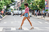 Stylish woman walking on street