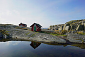 Wooden building on rocky coast