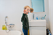 Boy brushing teeth in bathroom