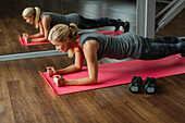 Woman exercising on mat