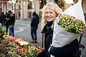 Smiling woman with bouquet of flowers