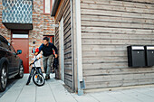 Father helping son with bike