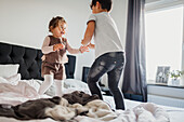 Brother playing with sister in bedroom