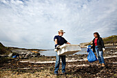 Couple cleaning coast