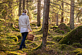Woman walking through forest