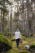 Woman walking through forest