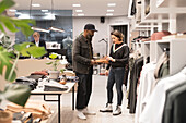 Shop assistant helping customer with shoes