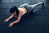 Woman exercising with foam roller