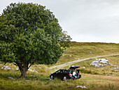 Couple sitting near car