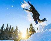 Boy jumping in snow