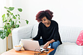 Woman sitting on sofa