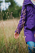 Girl walking in meadow in autumn