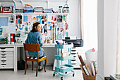 Young woman working in home workshop