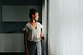 Woman looking through window