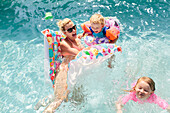 Mother with children in swimming-pool