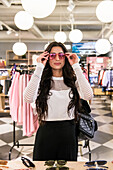 Woman in shop trying sunglasses