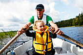 Grandfather and granddaughter rowing