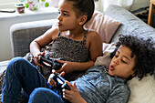 Brother and sister playing video game