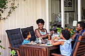 Family having meal outdoors