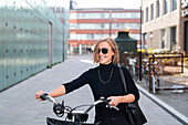 Smiling woman with bicycle