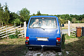 Children sitting in car trunk