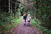 Girls running in forest