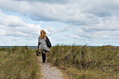 Woman walking towards sea