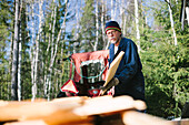 Man pilling up wooden boards