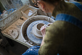 Potter using potters wheel