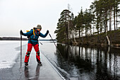 Ice skater on frozen lake